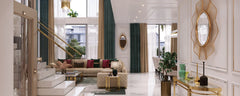 Double-height living room interior at Azizi Florence, Sharjah, featuring floor-to-ceiling windows, a marble staircase, elegant furnishings and gold decorative details.